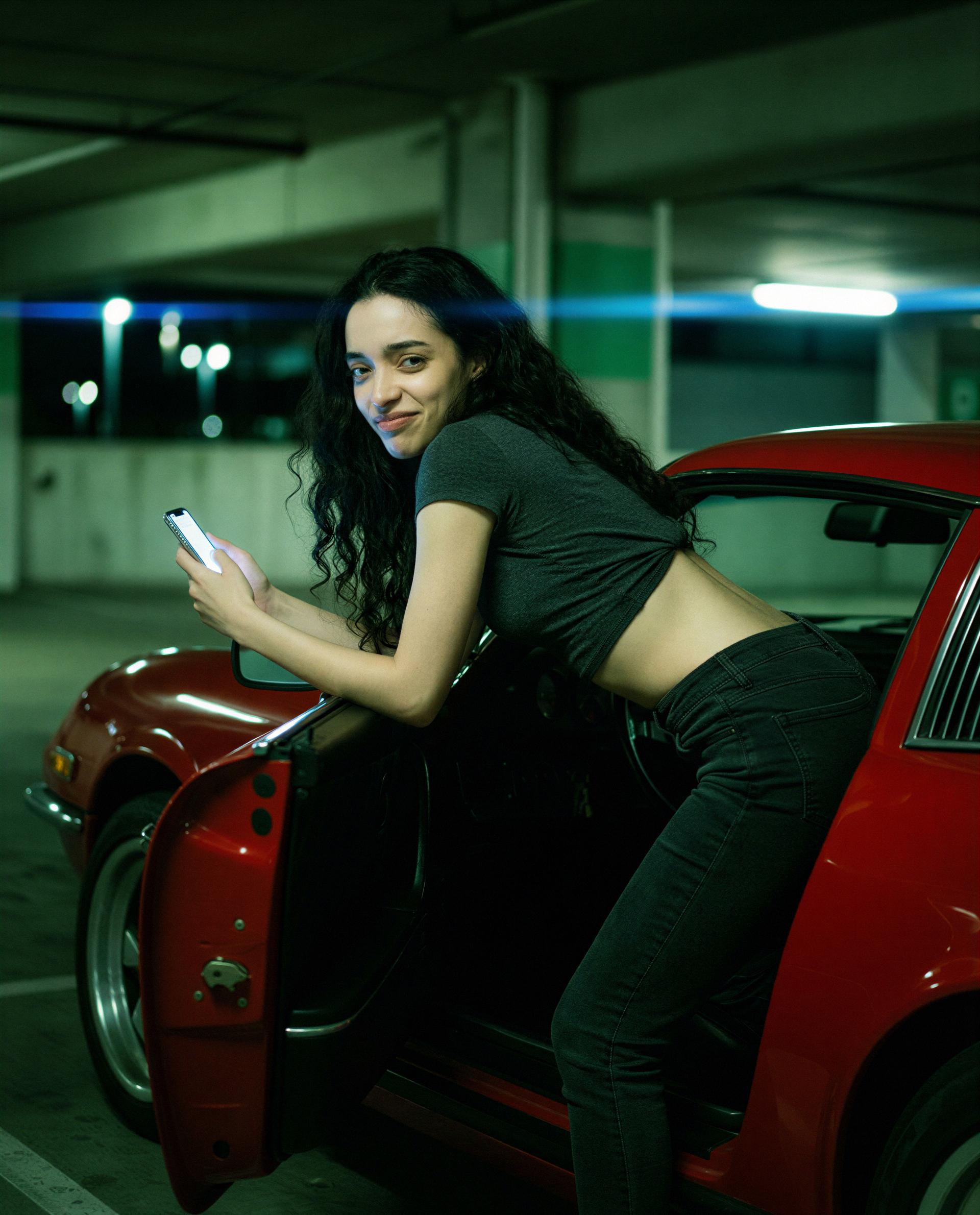 Red car, late night, me—be my co-pilot for something a little reckless? 😉, by Patricia Carvalho