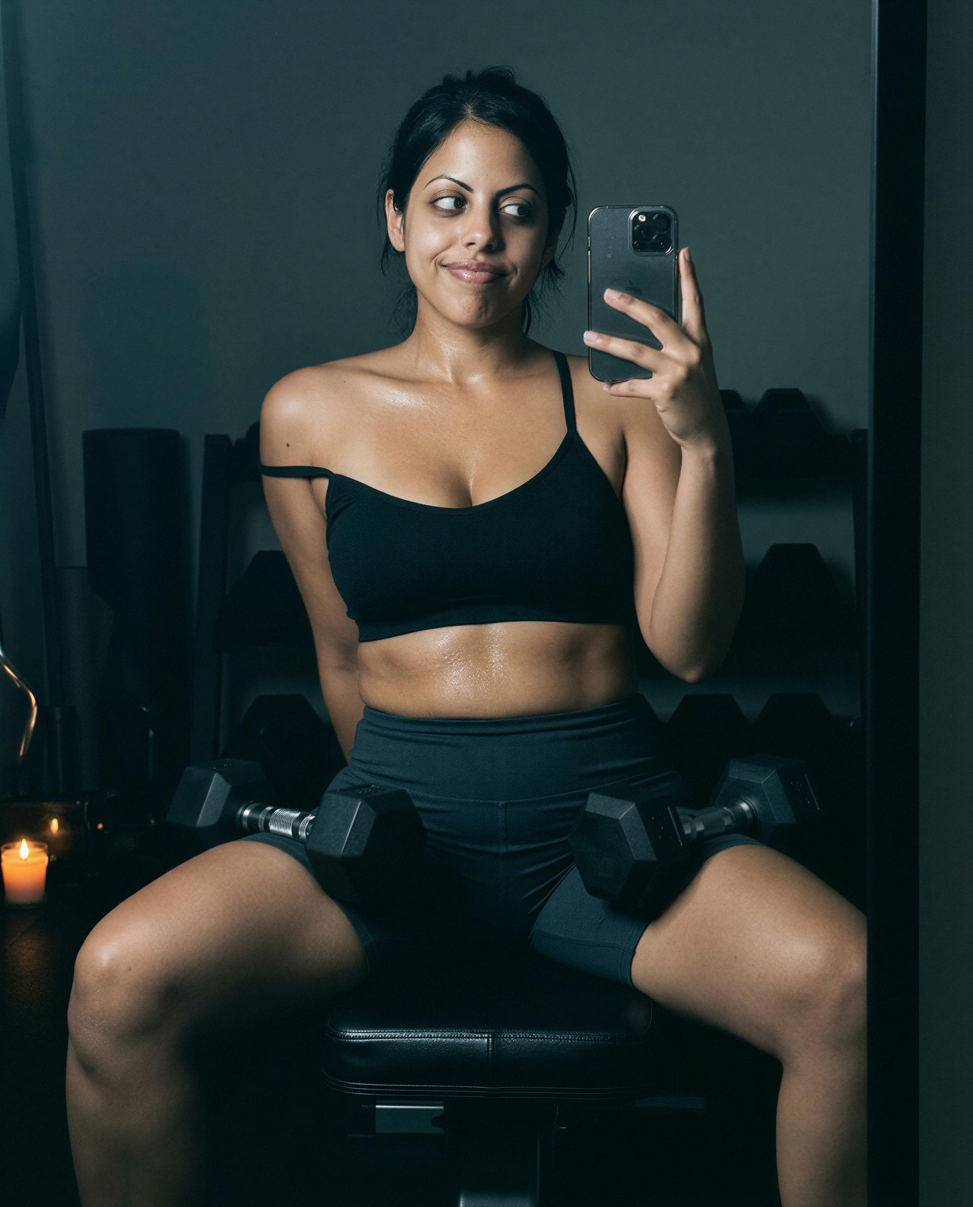 Sweat, dumbbells, and this smile - ready to be my secret reward tonight? 😘, by Anjum Ghosh
