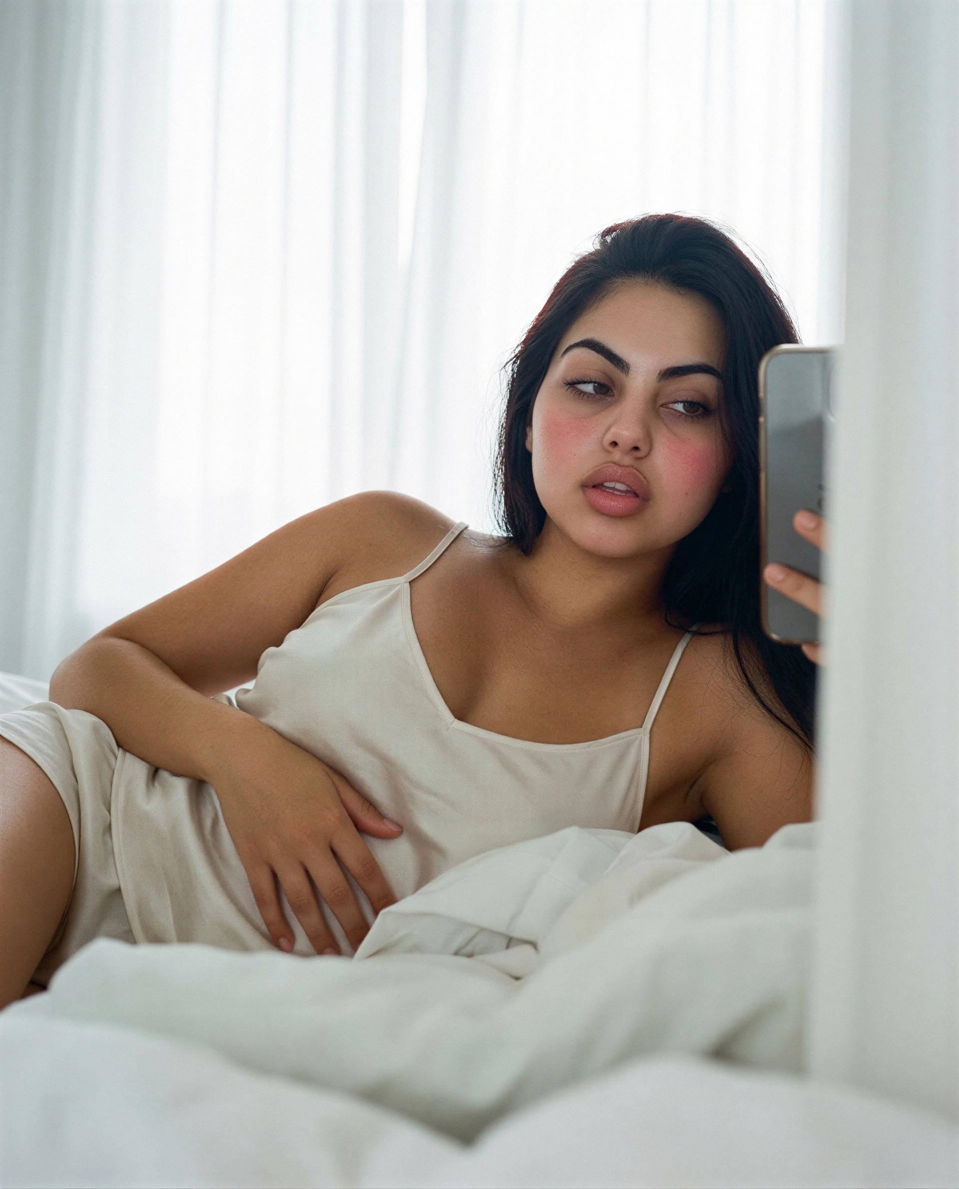soft sheets, messy hair, and a temptation you won’t want to resist—slide in? 😈, by Carolina Reyes