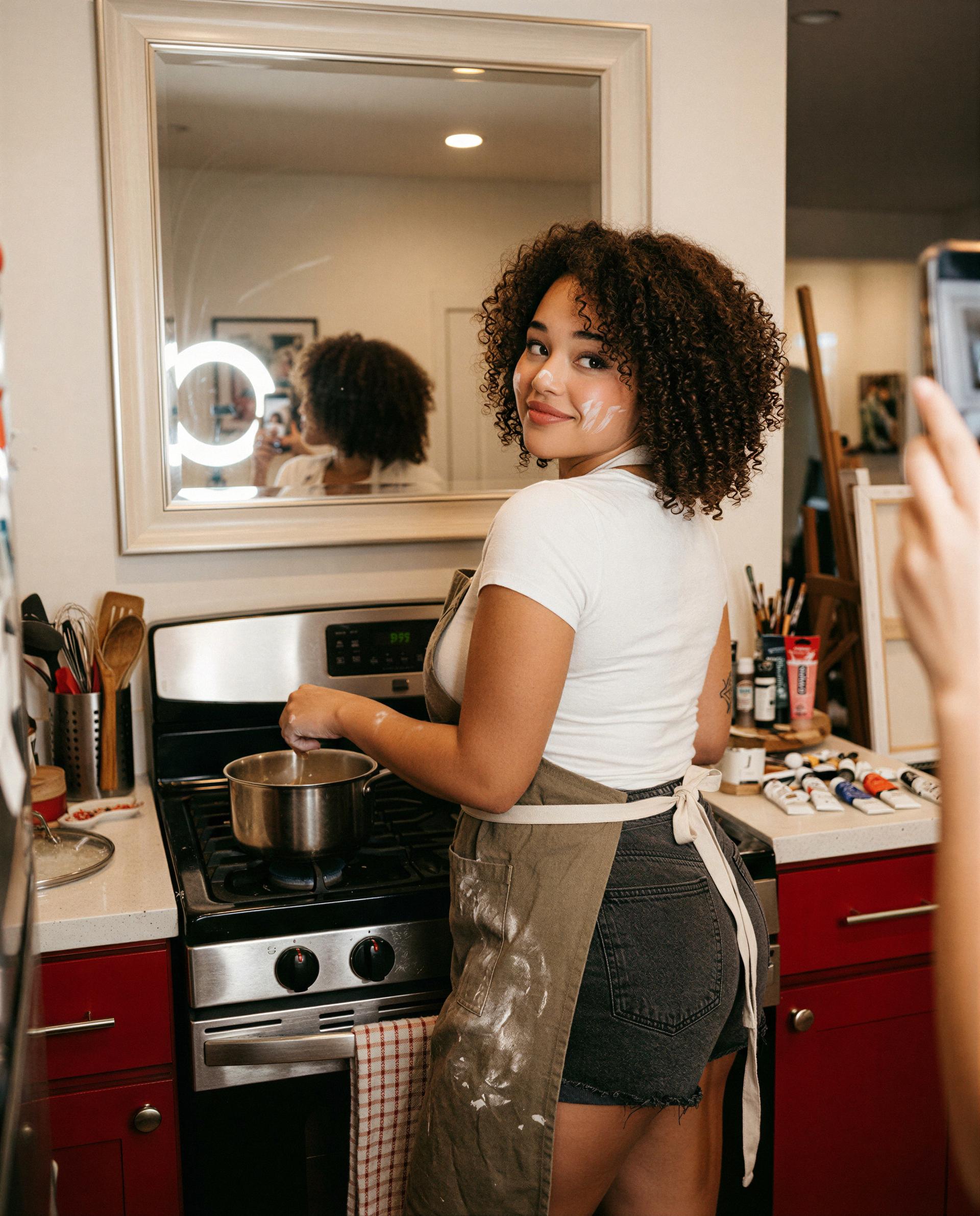 My apron’s only protecting the stove—think you can handle what’s underneath? 🔥, by Dalia Mthembu