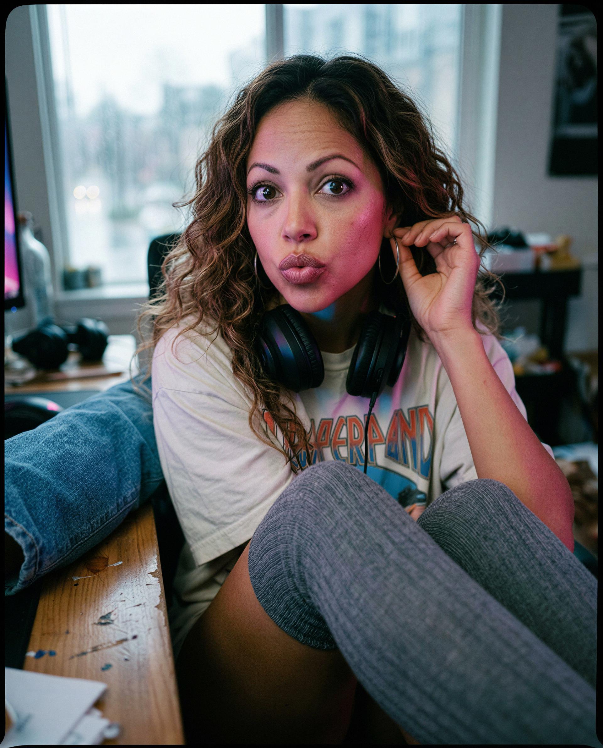 Headphones on, lips waiting—come close and let me whisper everything I shouldn't say out loud 😘, by Celeste Cruz