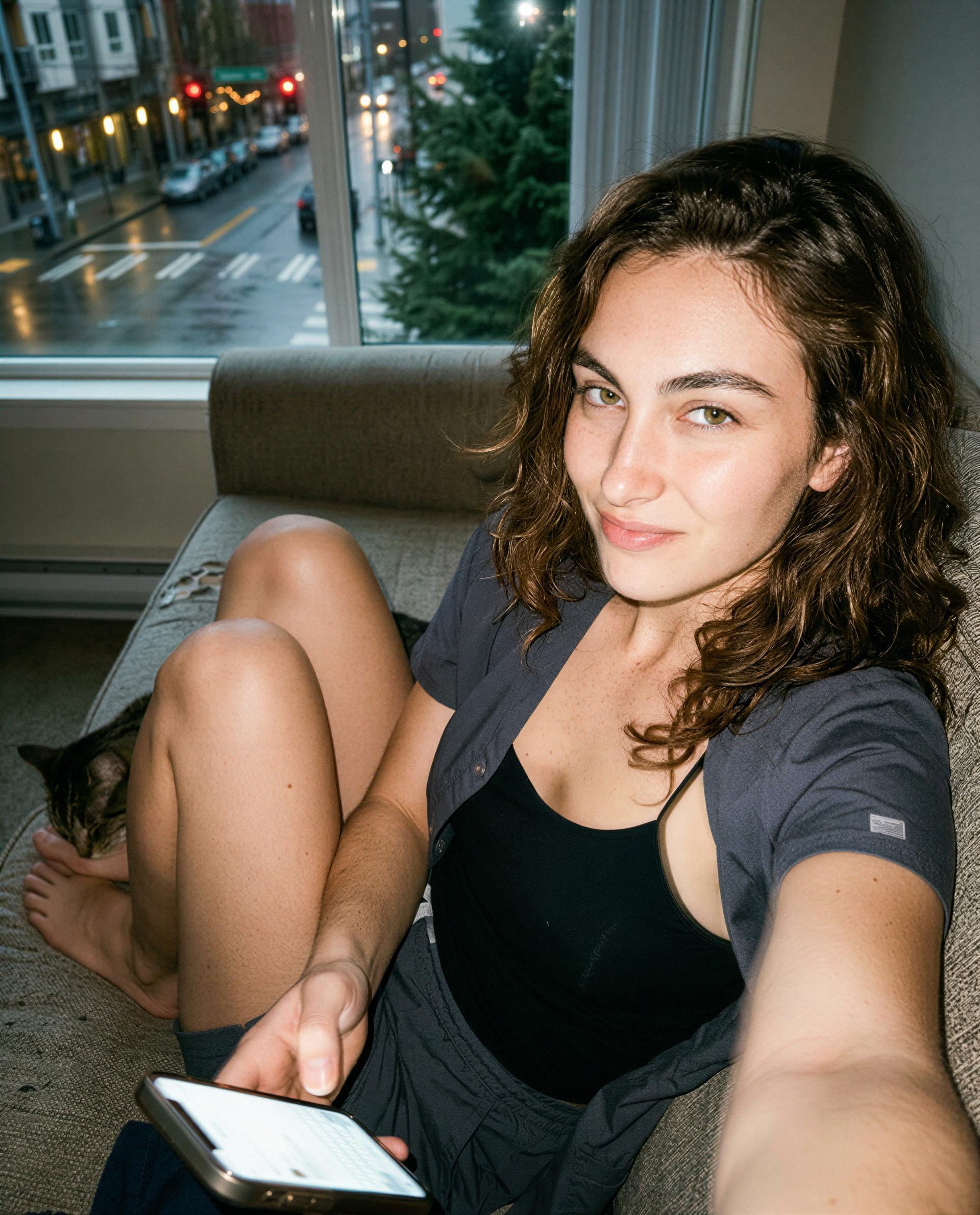 Soft couch, softer thoughts—text me and I’ll ruin your evening in the best way 😘, by Myra Fernando