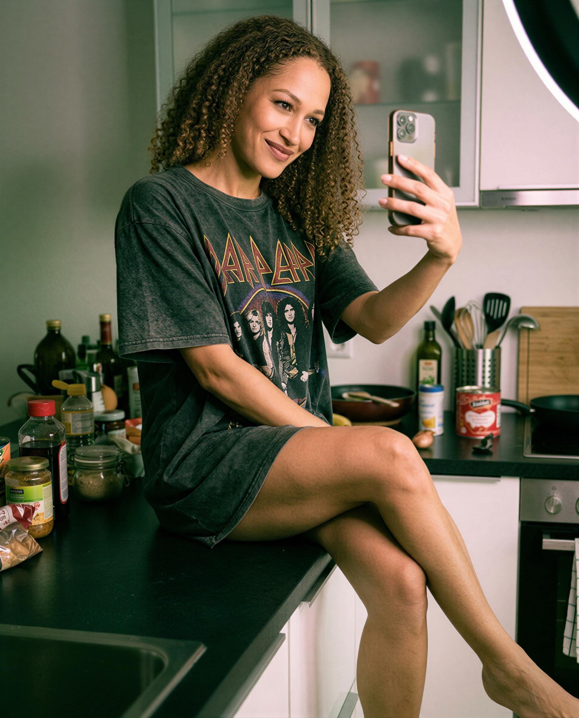 Vintage tee, crossed legs, and a private invite - curious enough to DM me? 💕, by Carmen Rodriguez