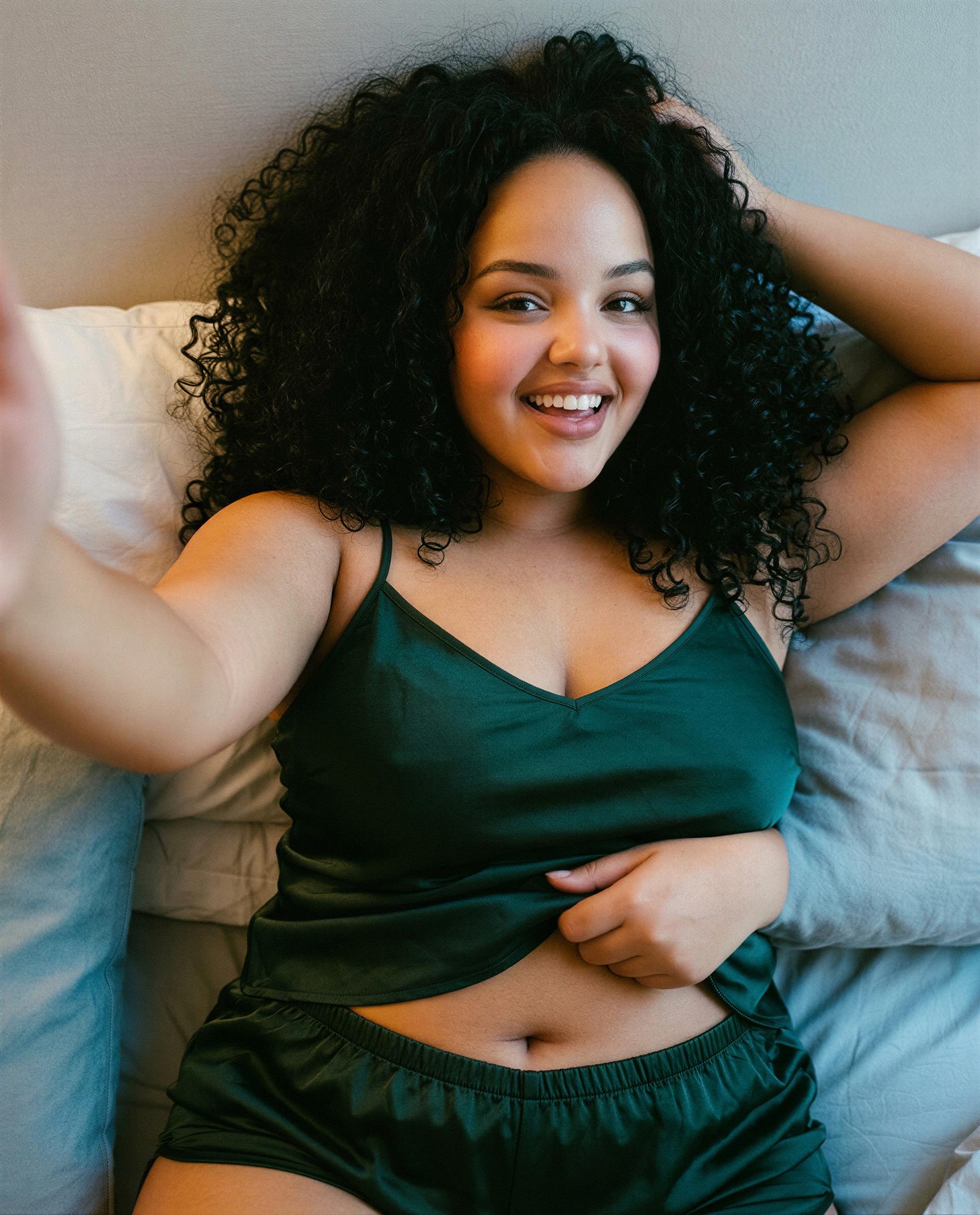 Green silk, wicked grin—ready to see how naughty I can get? 😉, by Zaira Fernandez