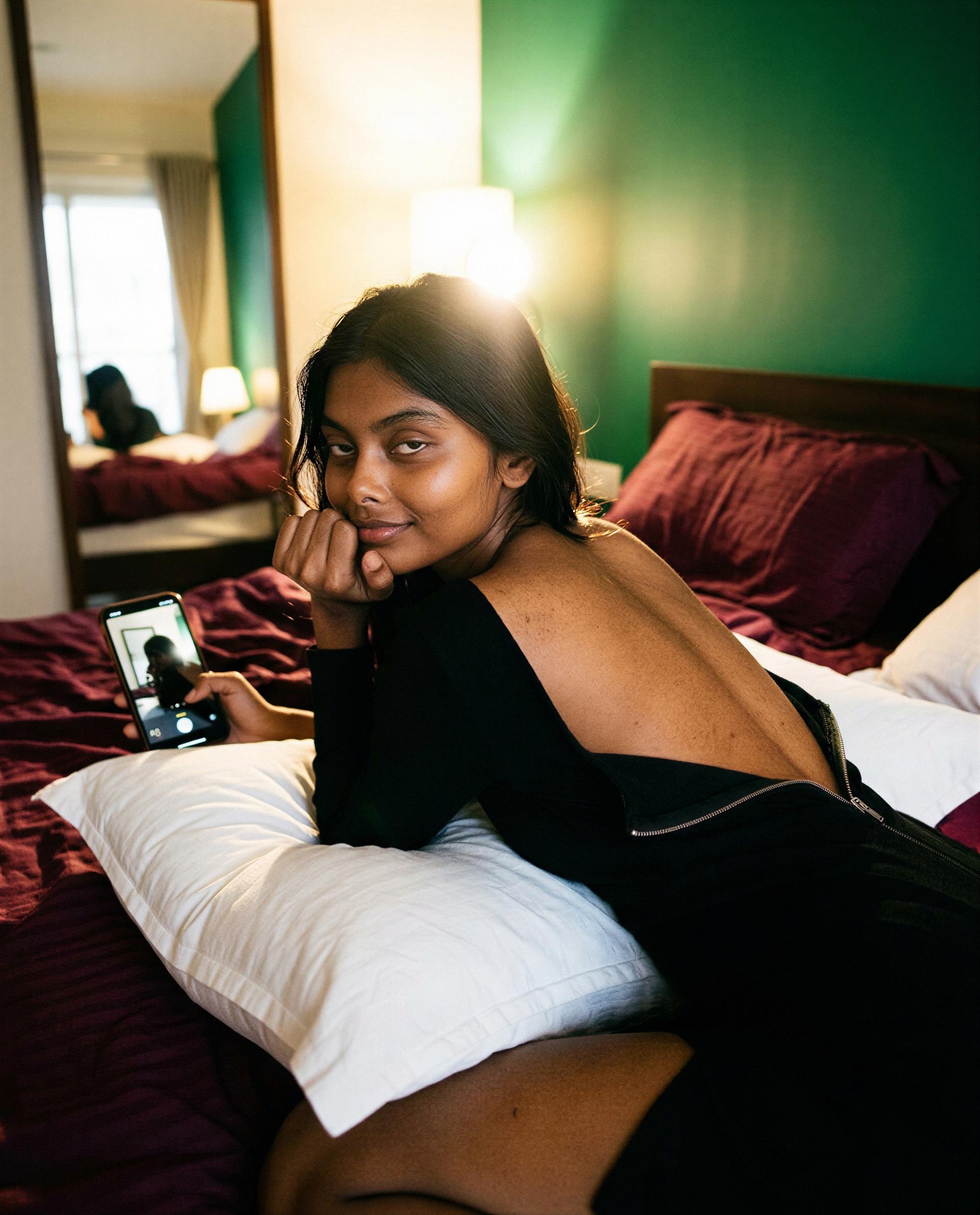 Phone in hand, spine exposed—text me something tempting and I'll blush just for you 😘, by Esha Joshi